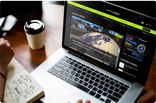 Laptop displaying MetaMoon Media website with coffee cup and financial charts on wooden desk